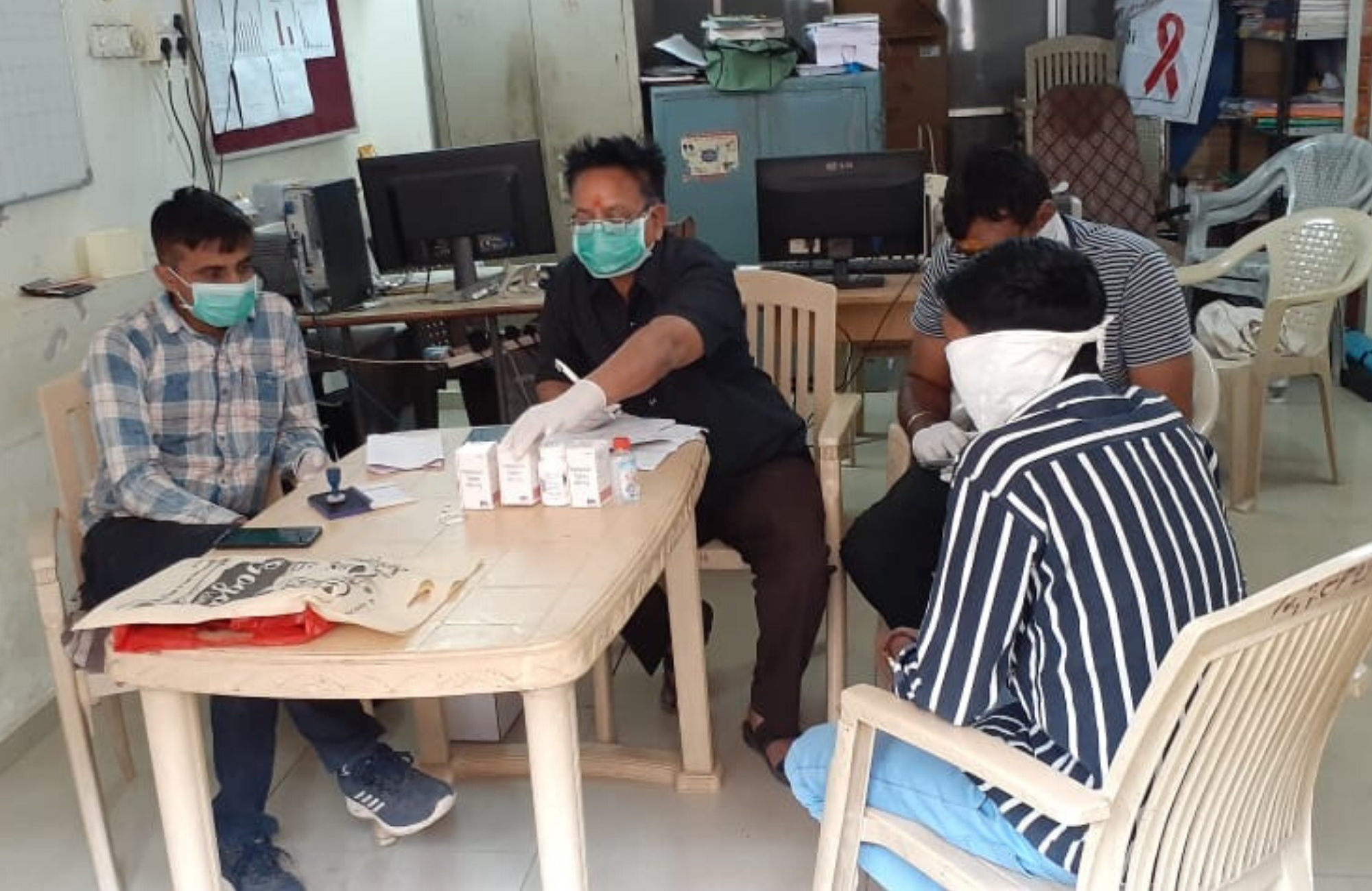 Volunteers packing medicines for delivery at an ART Centre. Image: Gujarat AIDS Prevention