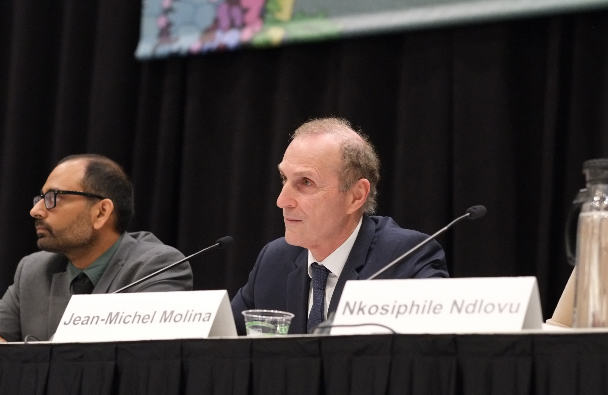 Professor Jean-Michel Molina at CROI 2026. He is sitting behind a microphone, with another man sitting beside him.