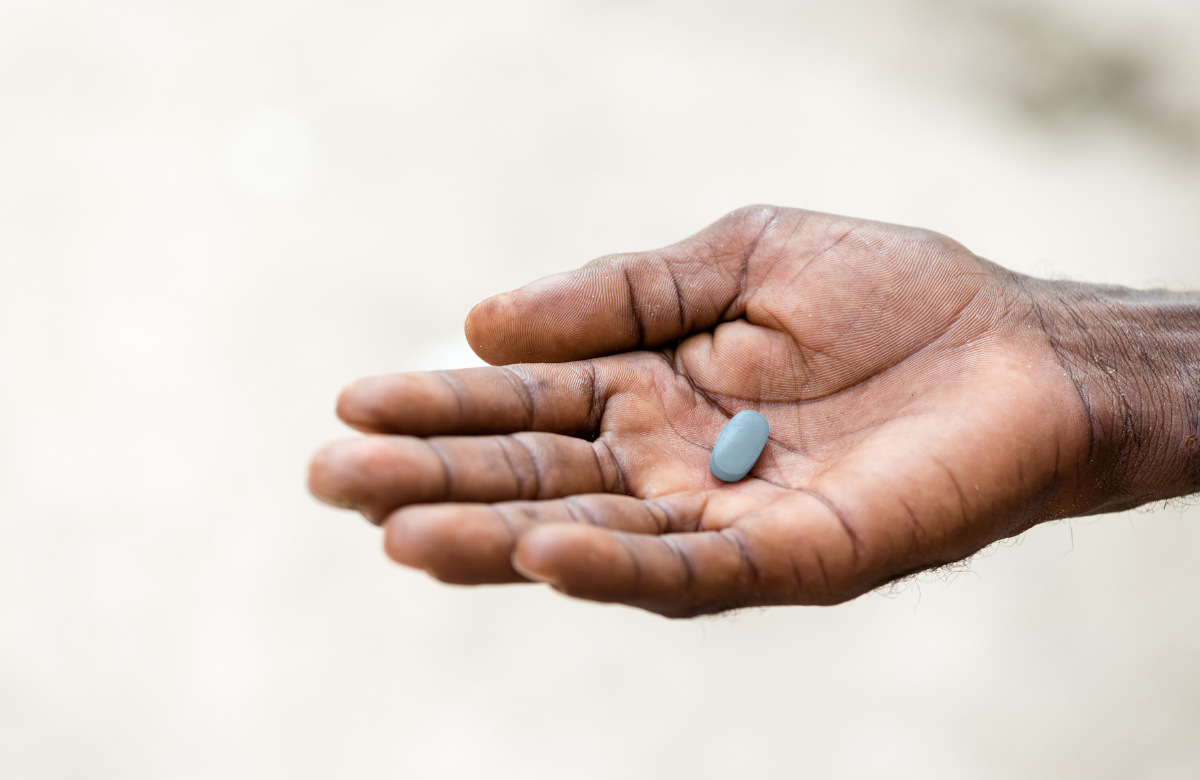 PrEP medication in the palm of a hand