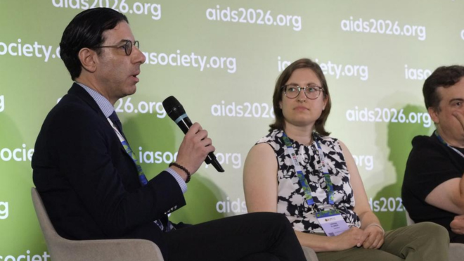 Dr Wissam El Atrouni and Dr Carina Elsner at AIDS 2026. Wissam is on the left talking into a microphone.