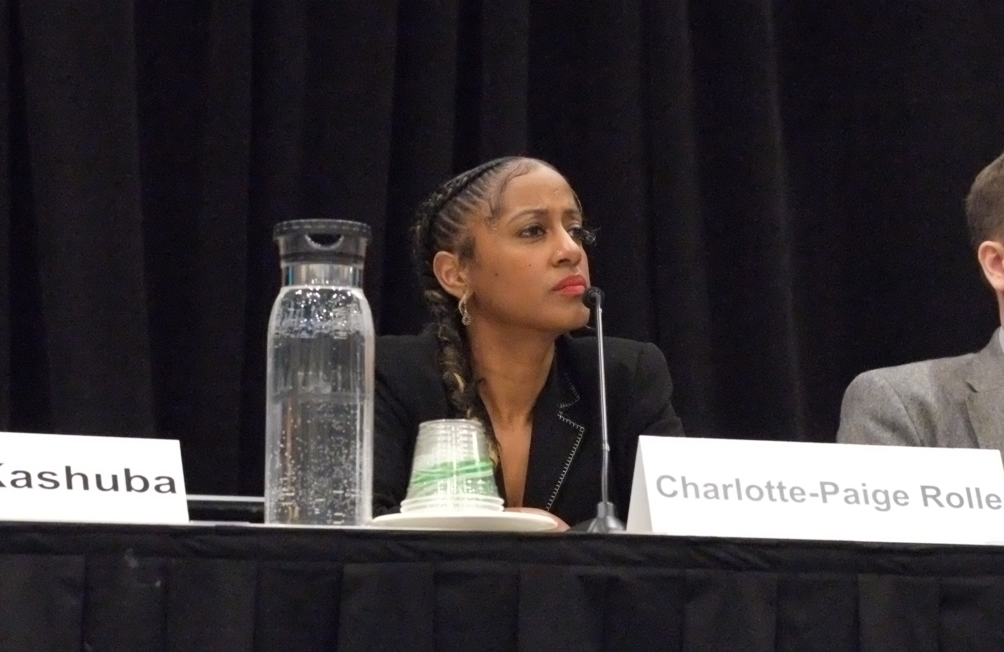 Dr Charlotte-Paige Rolle at CROI 2026. She is sitting down, with a small microphone in front of her.