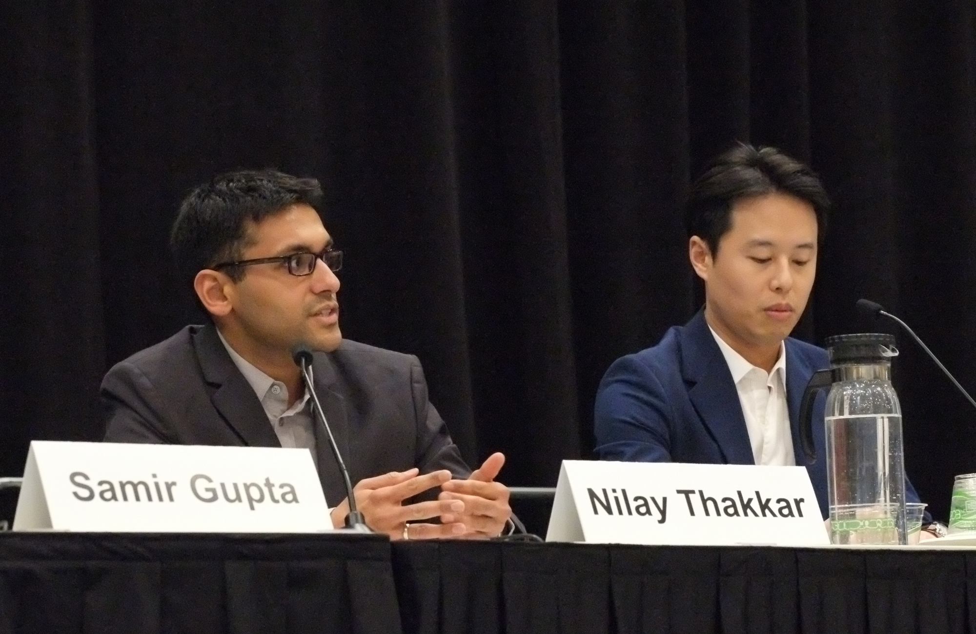 Dr Nilay Thakkar (left) and Dr Hyunmoon Back (right) at CROI 2026. They are sitting next to each other with Nilay talking into a microphone.