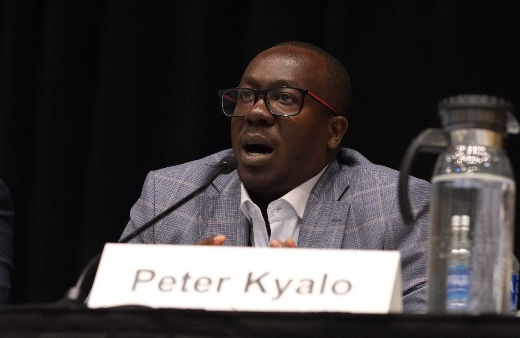 Dr Peter Kyalo at CROI 2026. He is talking into a microphone.