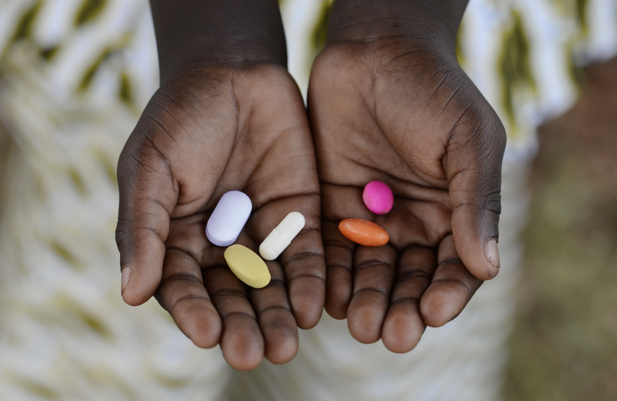 Person holding pills in their hands.