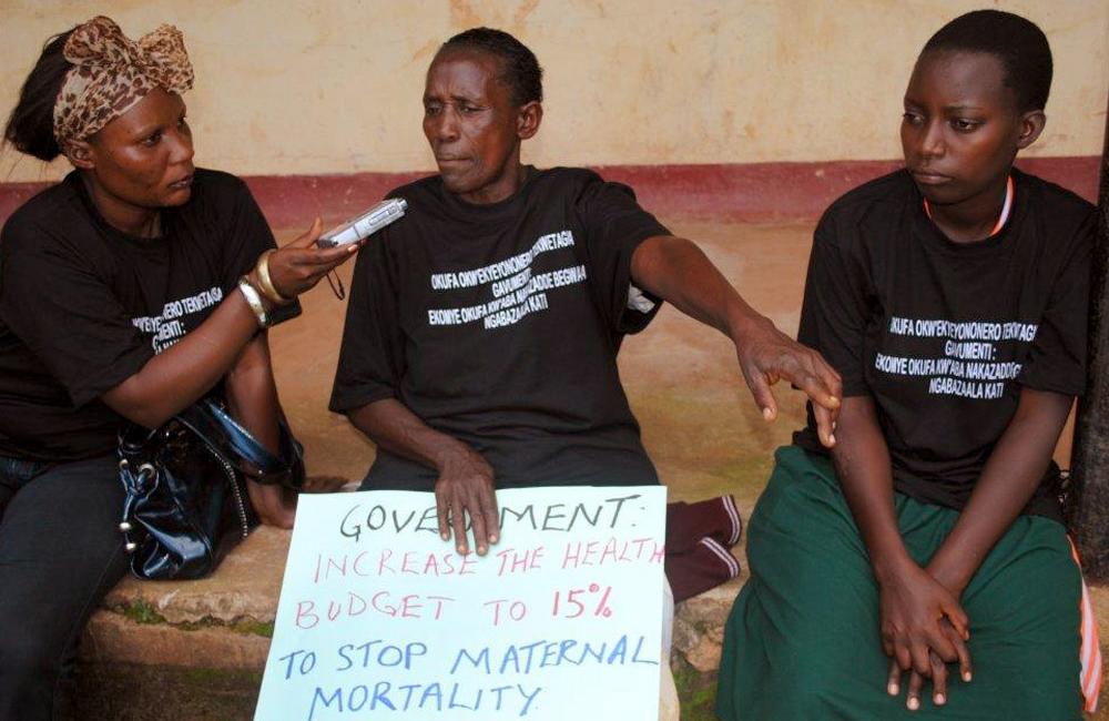 Key Correspondent Sharifah Nabukenya interviewing people at a protest march in Uganda.