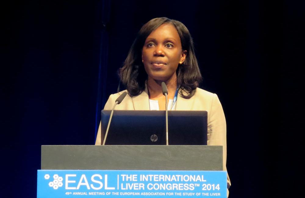 Anu Osinusi, from the U.S. National Institute of Allergy and Infectious Diseases, speaking at the International Liver Congress 2014. Photo by Liz Highleyman, hivandhepatitis.com.
