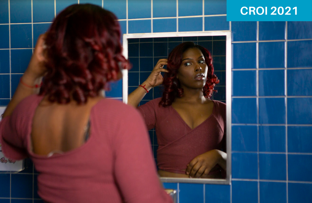 A young transgender woman looking in the bathroom mirror. The Gender Spectrum Collection. Image is for illustrative purposes only.