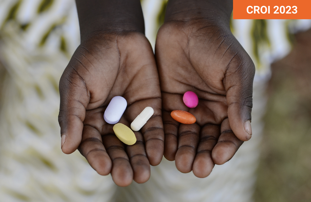 Riccardo Mayer/Shutterstock.com. Person holding pills in their hands.