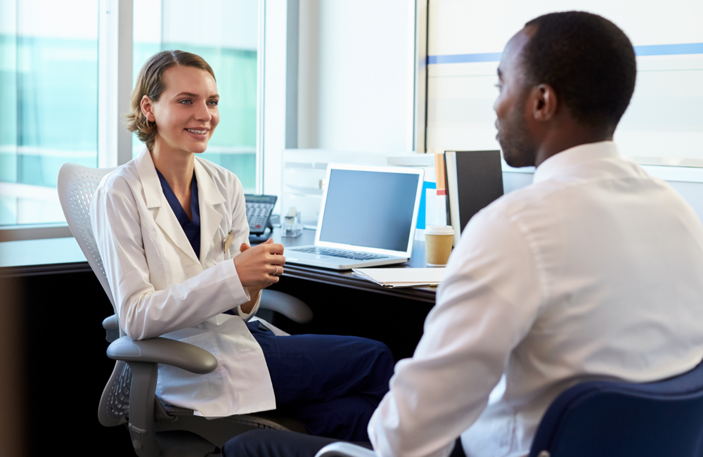Monkey Business Images/Shutterstock.com A doctor and patient talking in a doctor's office.