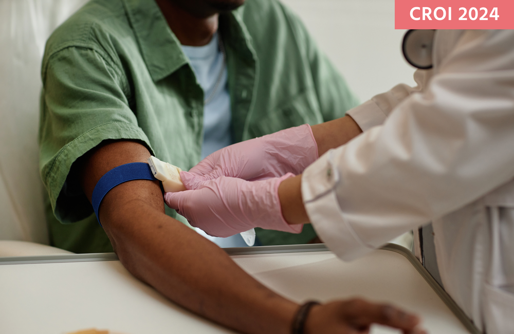 A nurse preparing a patient for a blood test by putting a tourniquet around their arm.