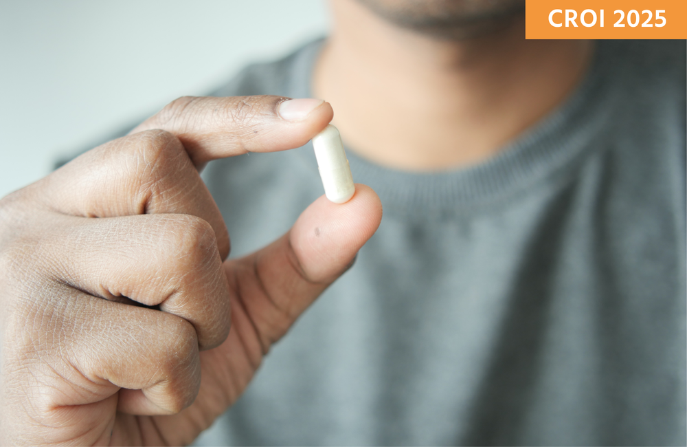 @towfiqu/Canva A person in a grey tshirt holding a white pill.