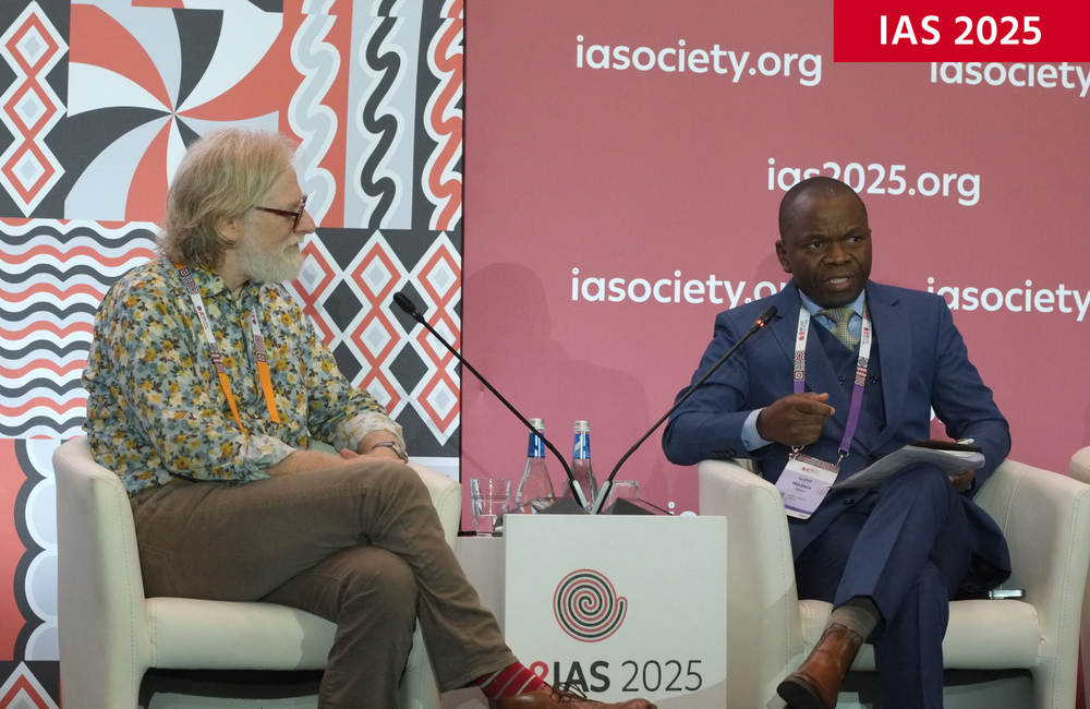 Mitchell Warren and Professor Lloyd Mulenga at IAS 2025. Image: Roger Pebody. Mitchell Warren (left) and Professor Lloyd Mulenga (right) at IAS 2025. They are both sitting on grey chairs with microphones close by.