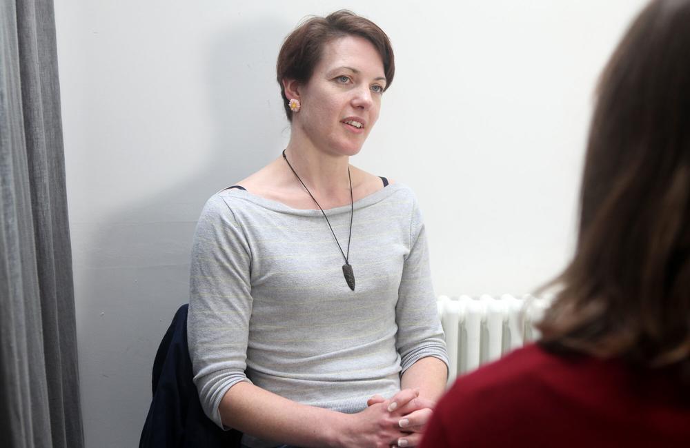 A woman talks to a clinician.