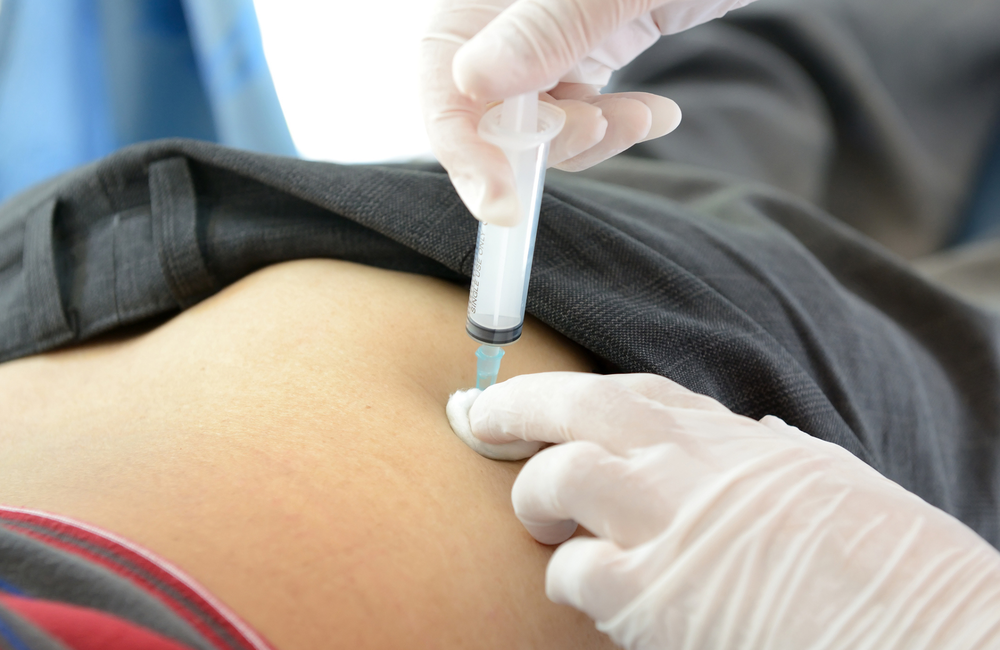 An injection is being given into someone's buttocks.