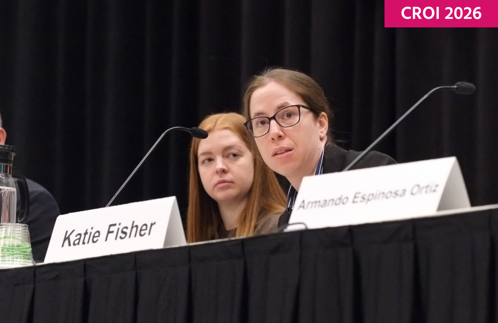 Dr Katie Fisher from Aarhus University in Denmark at CROI 2026. She is talking into a microphone.