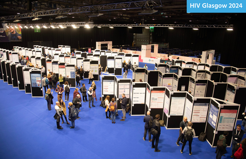 A conference room with poster panels and attendees moving between them