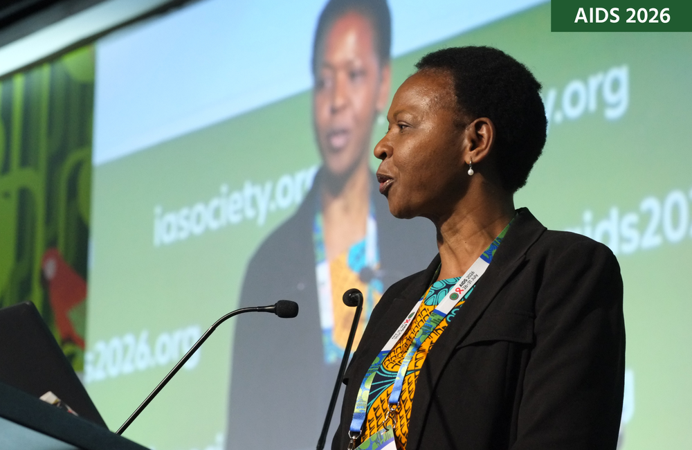 Dr Mutsa Bwakura Dangarembizi at AIDS 2026. She is talking into a microphone with a screen behind her.