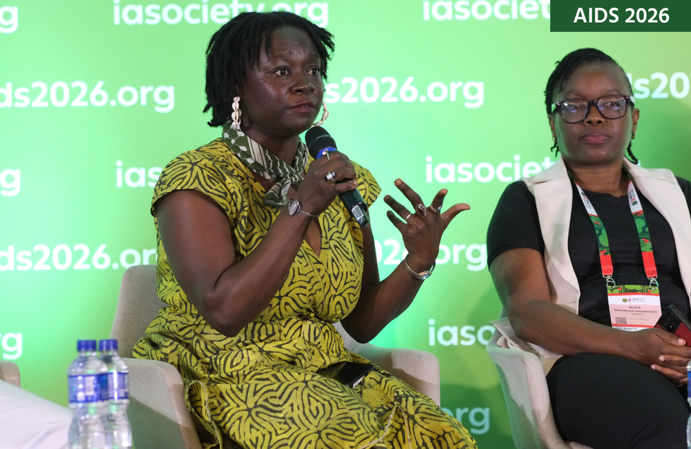 Dr Akua Gyamerah (left) and Ruth Kikonyogo (right) at AIDS 2026. Akua is talking into a microphone.